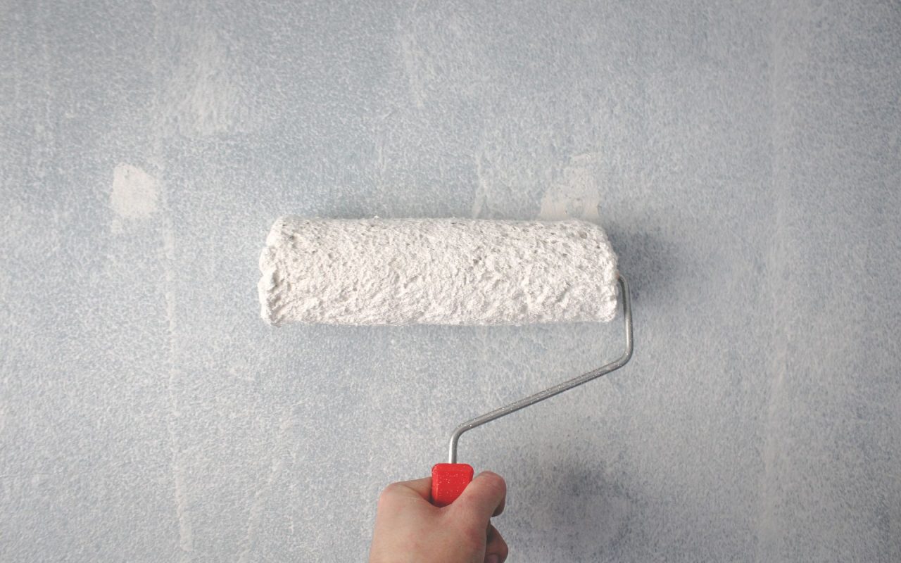 Rouleau appliquant une peinture sur un mur intérieur